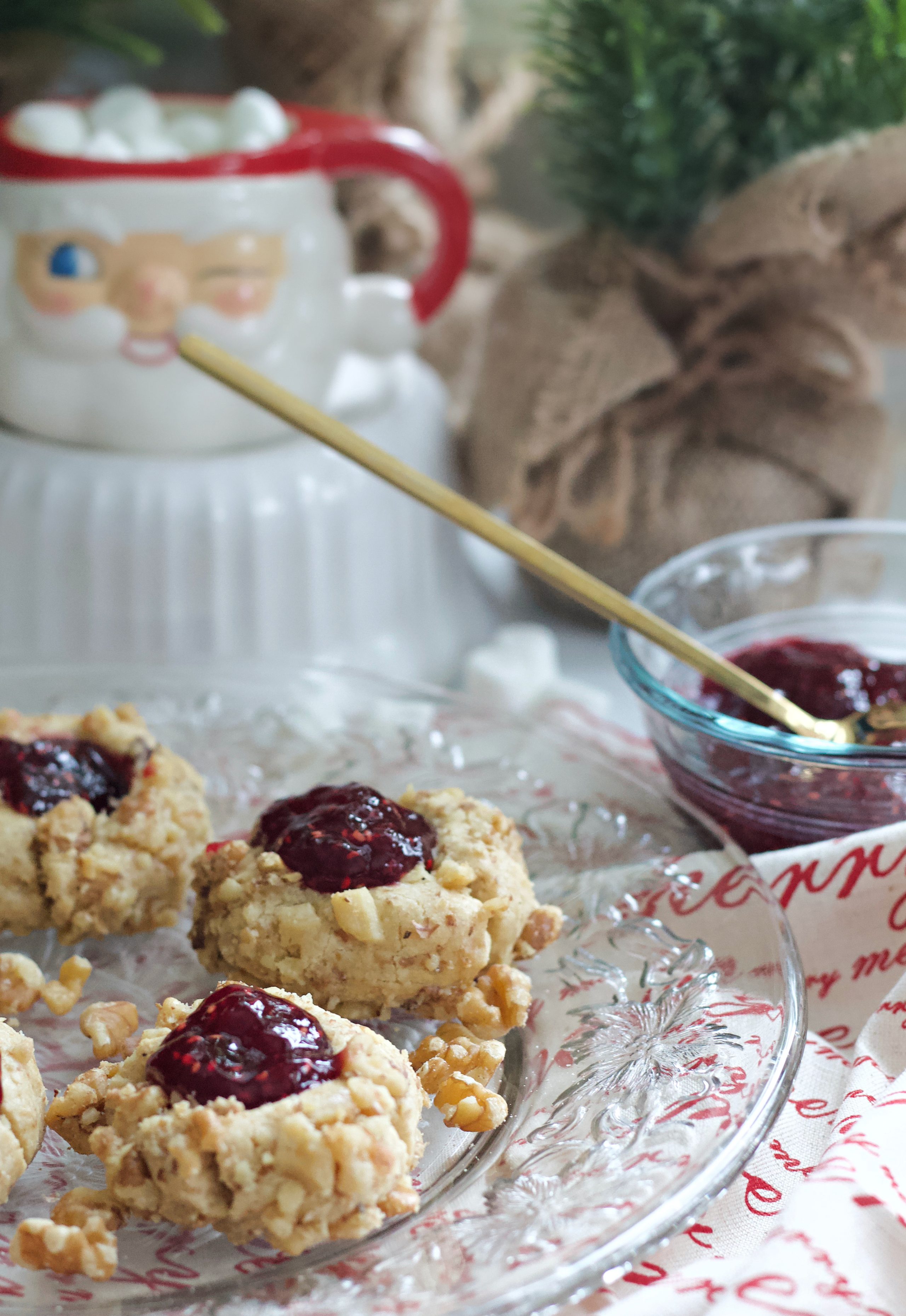 These thumbprint cookies have a rich, buttery flavor with crushed walnuts and raspberry preserves. You'll never use another recipe again. #christmascookies #thumbprint cookies #cookies