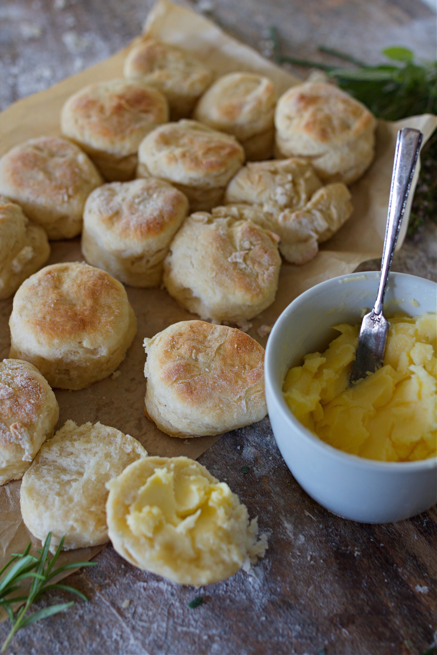 Biscuits fresh out of oven sitting beside butter on counter. 