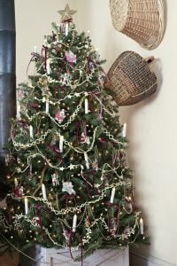 Christmas tree with satin Burgundy bows, candles, garland, and vintage ornaments.