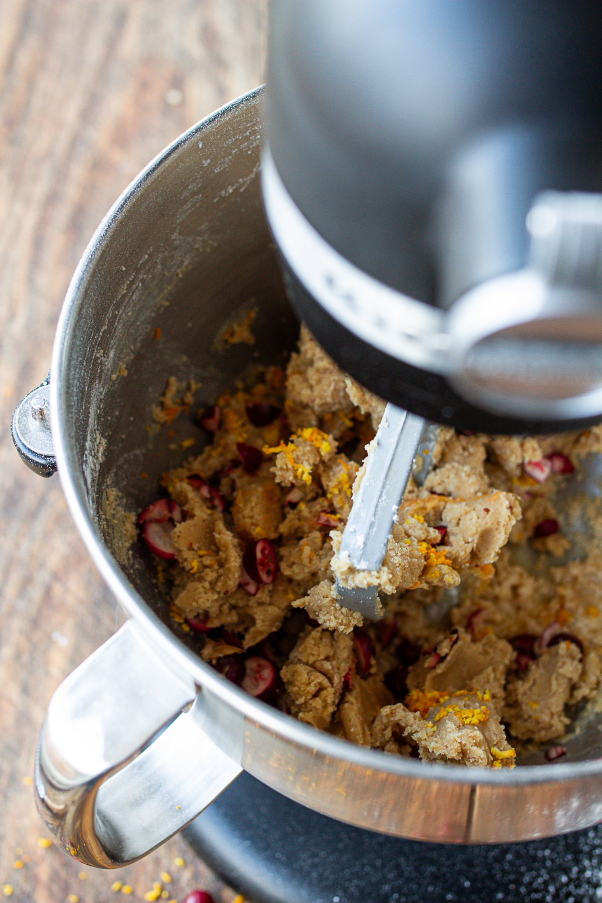 adding cranberries and orange zest to dough in kitchen-aid.