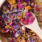 wooden bowl filled with dried flowers for potpourri.