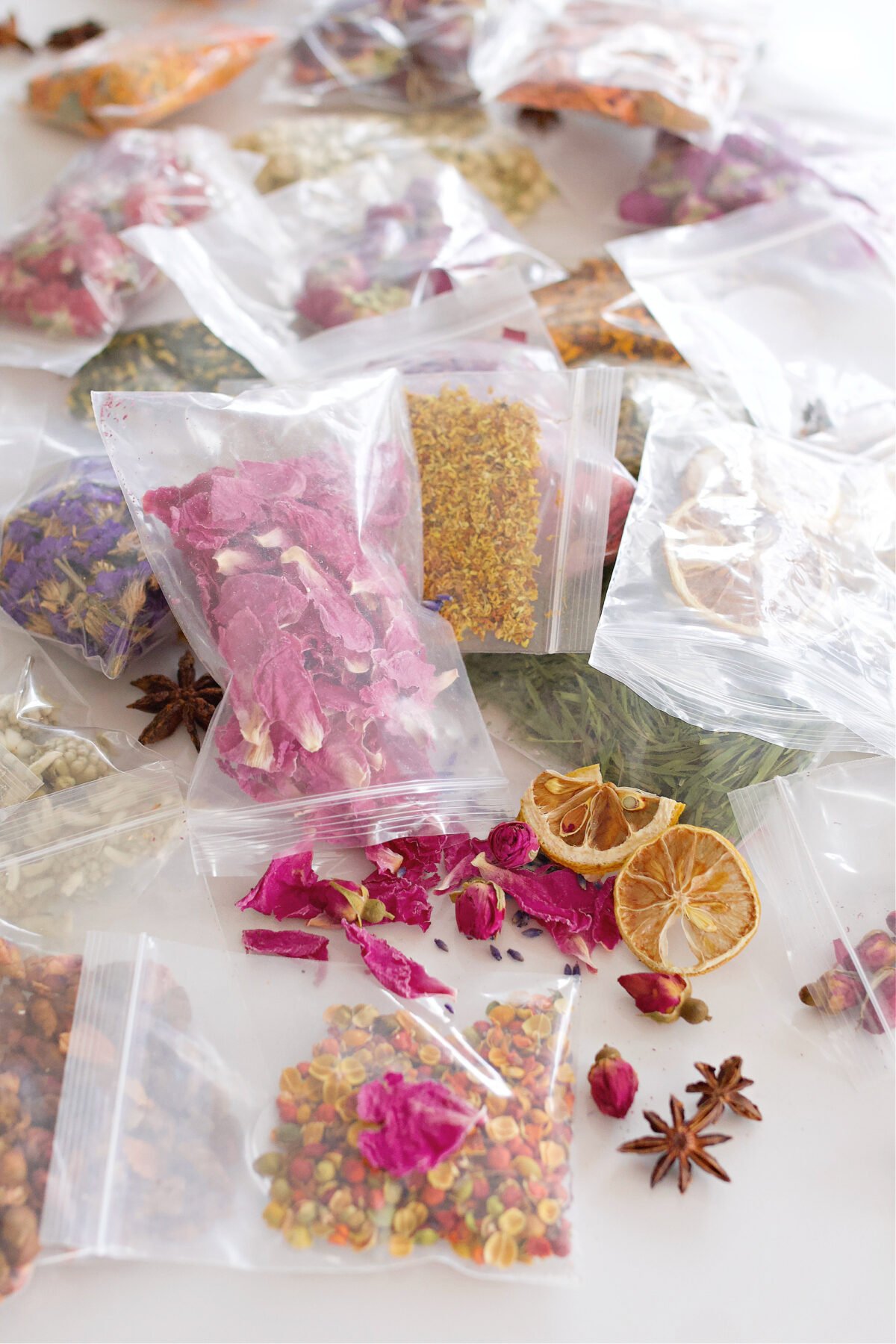 Bags of dried flowers on counter for making potpourri. 