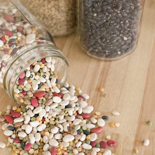 beans in mason jars on a wooden counter.