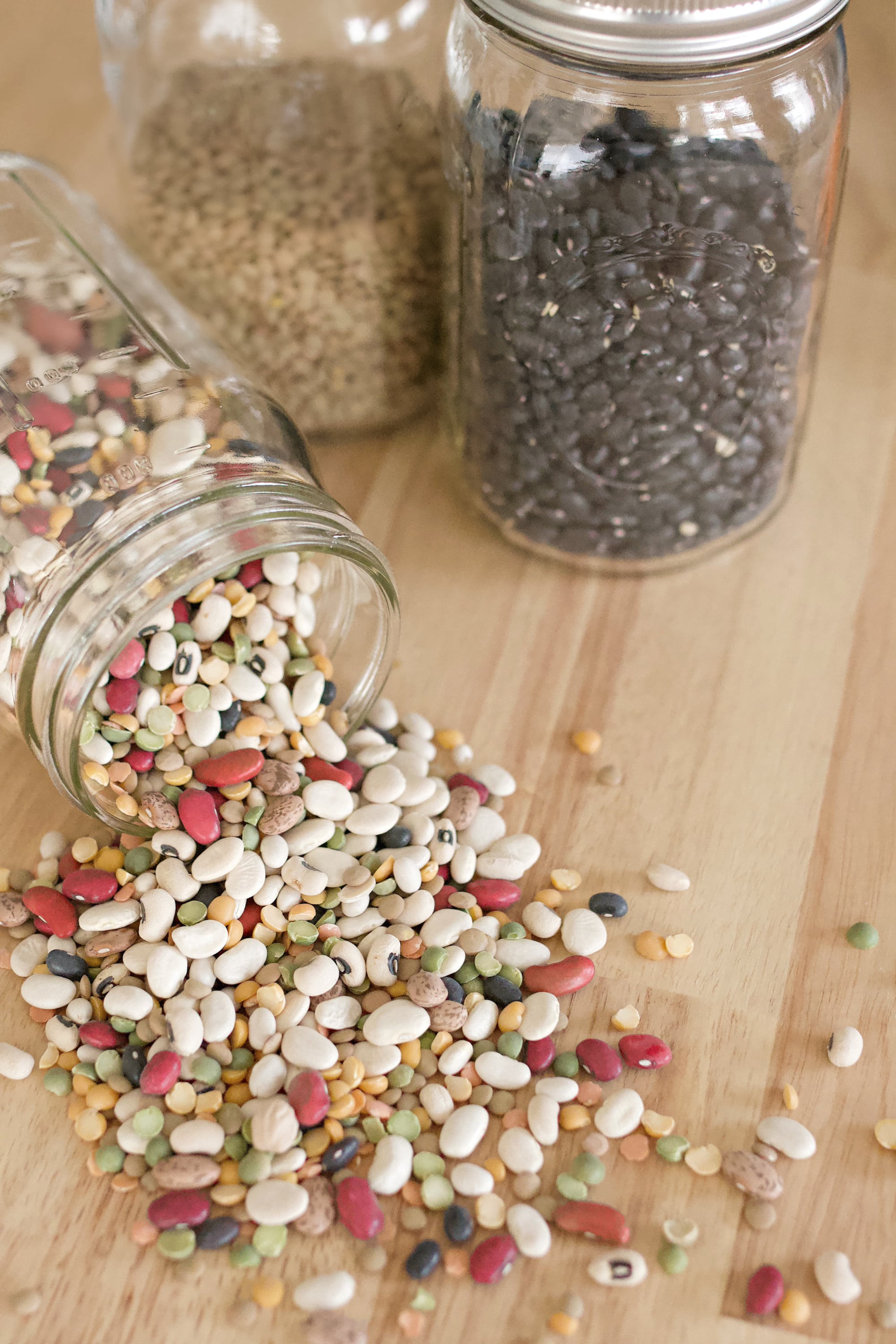 beans in mason jars on a wooden counter.