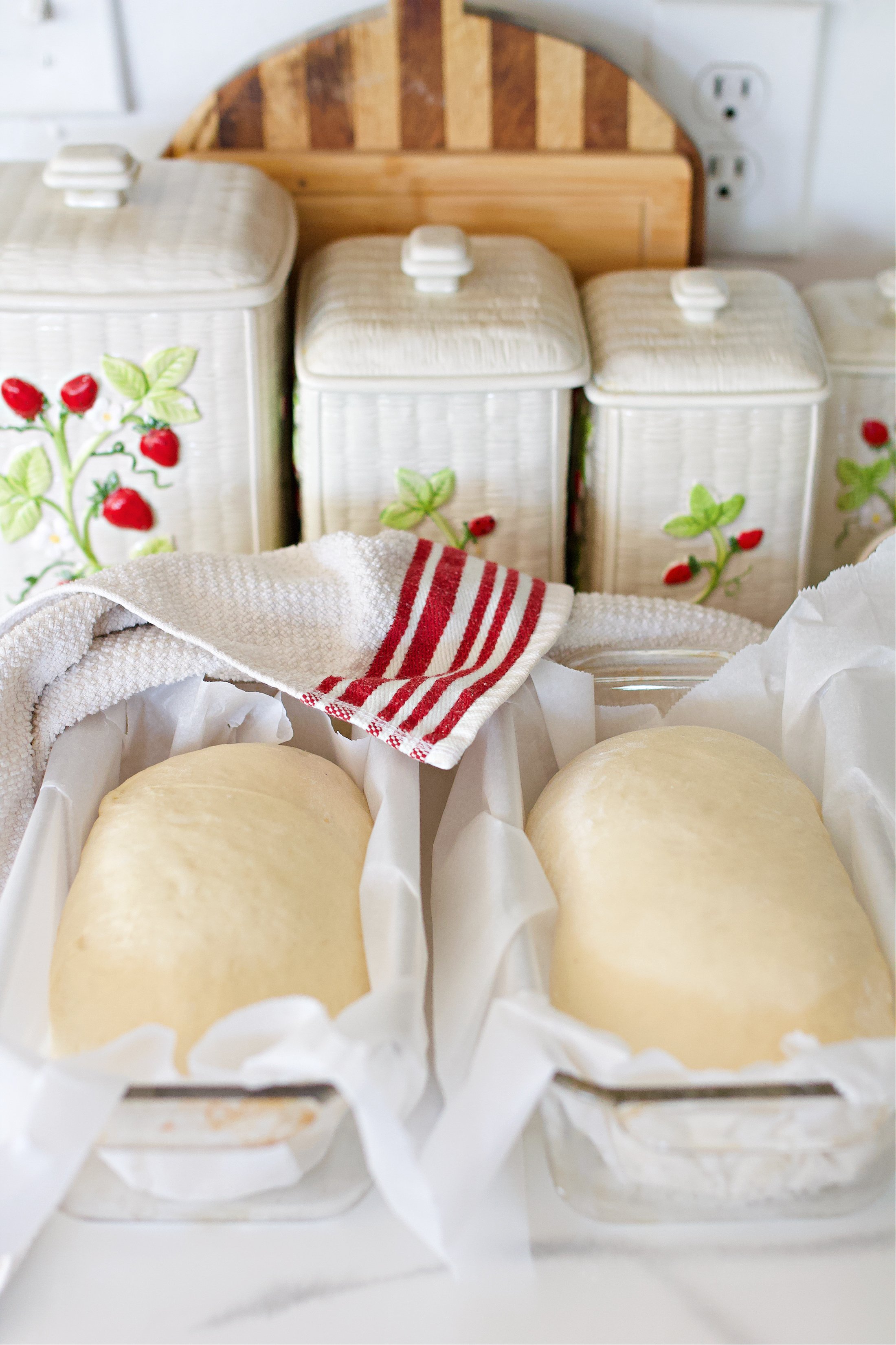 Sandwich bread dough in glass baking dishes after second rise ready to bake.
