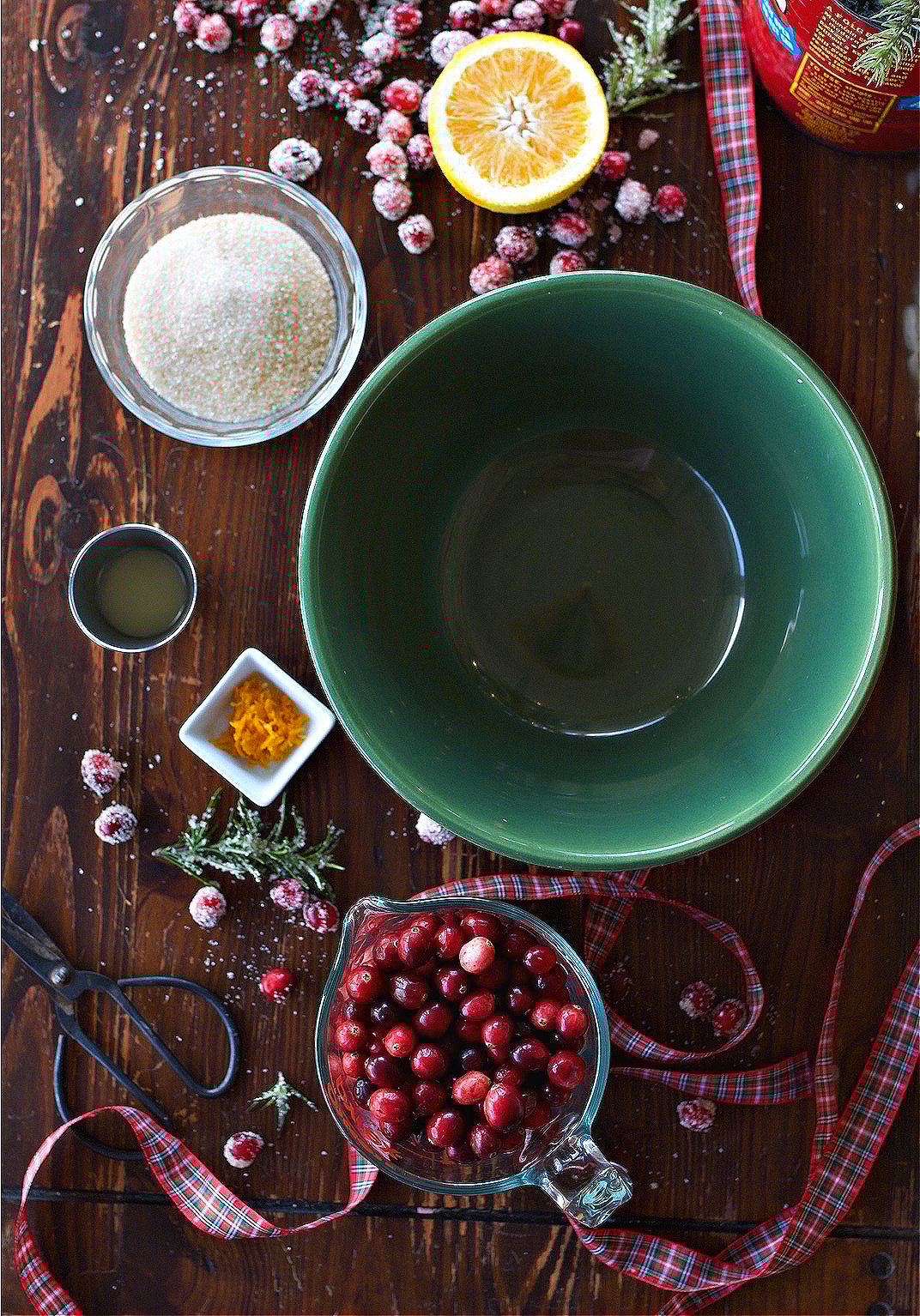 Tart ingredients on counter: cranberries, orange zest, lemon juice, and sugar.