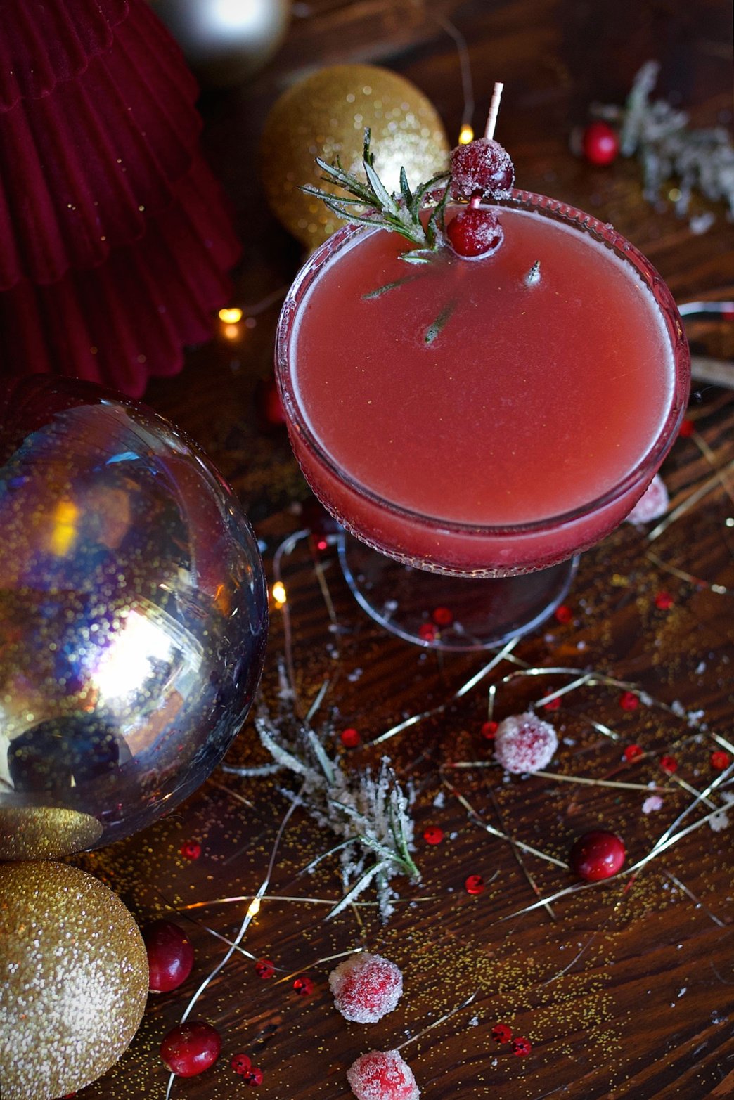 Cranberry spritzer on counter with garnish ready to drink. 