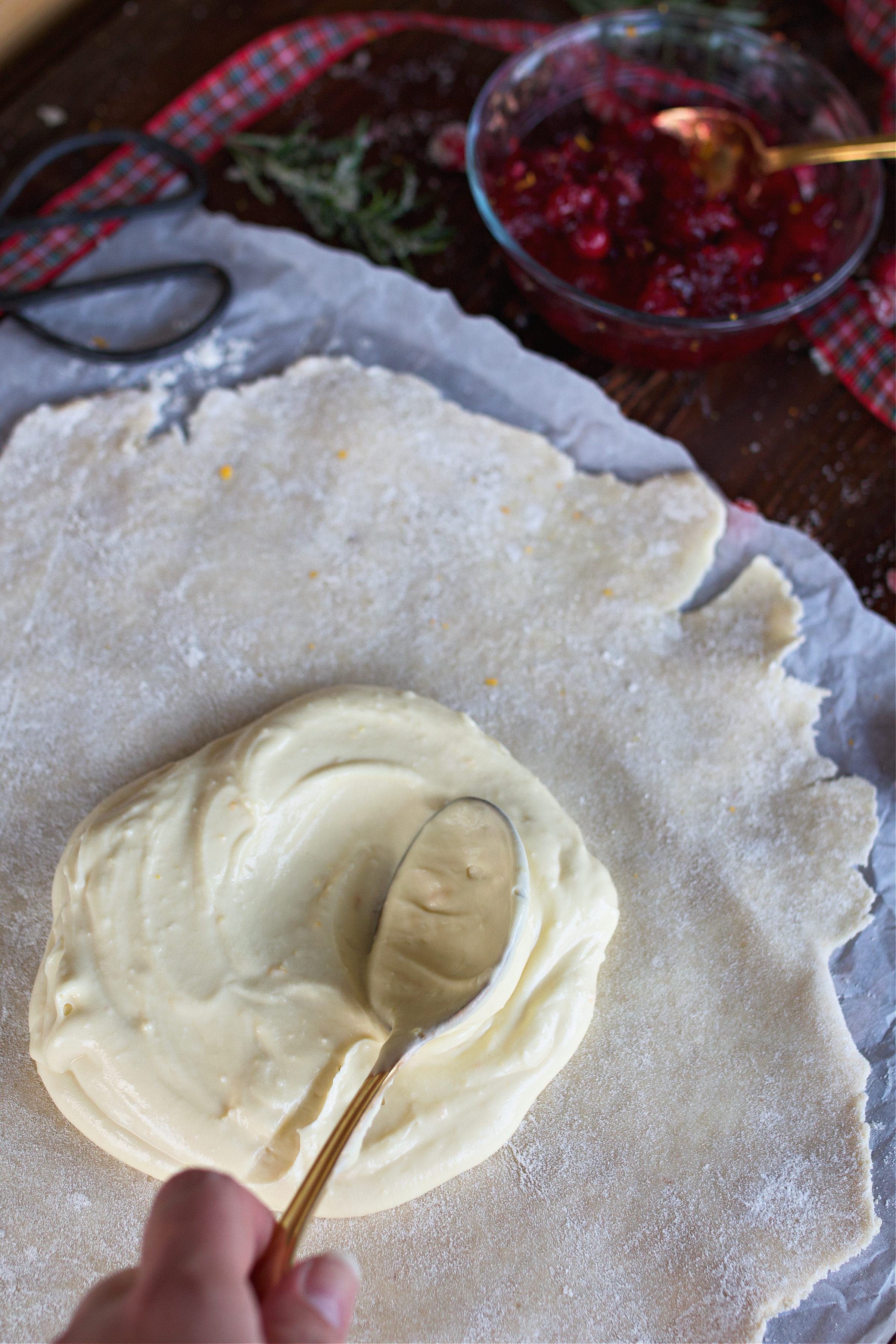 Cream cheese base being spread on tart crust.