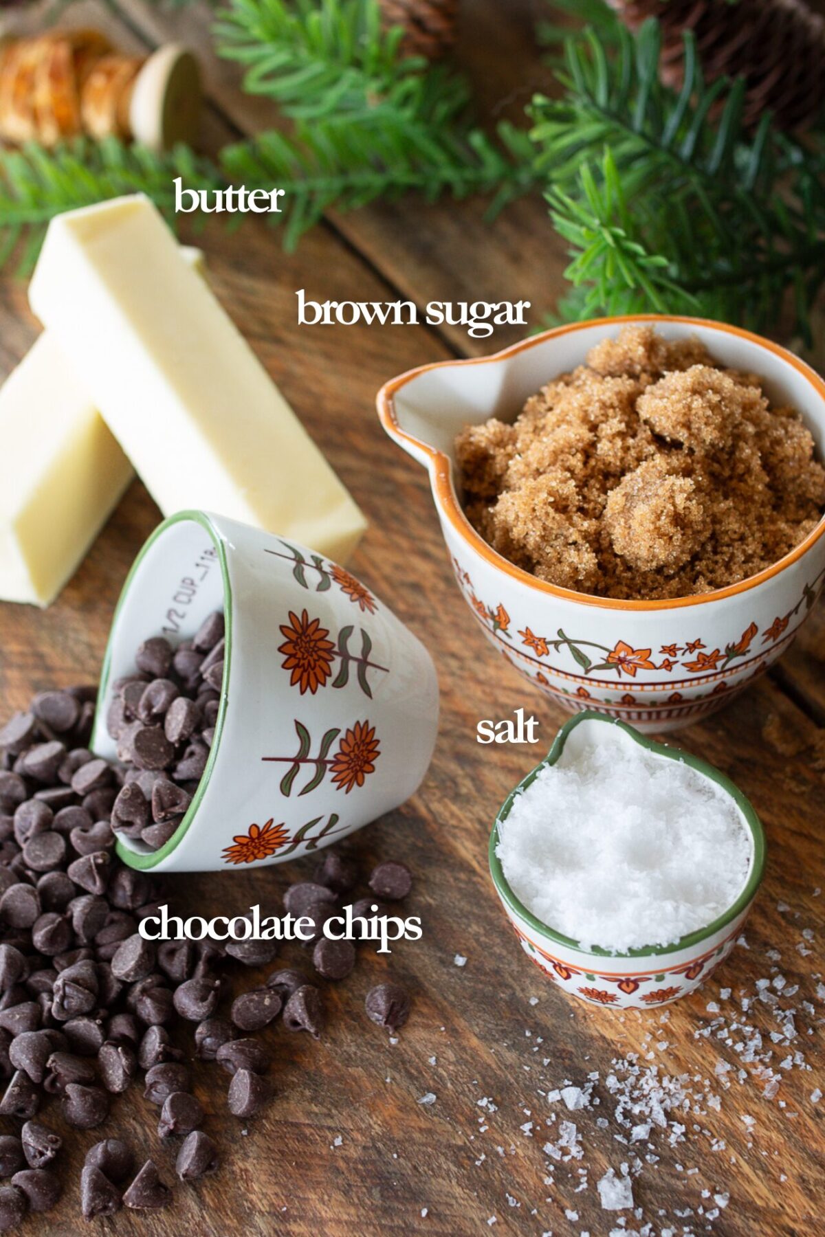 Ingredients for toffee on counter. 2 sticks of butter, ½ cup chocolate chips, 1 cup brown sugar, and sea salt flakes.