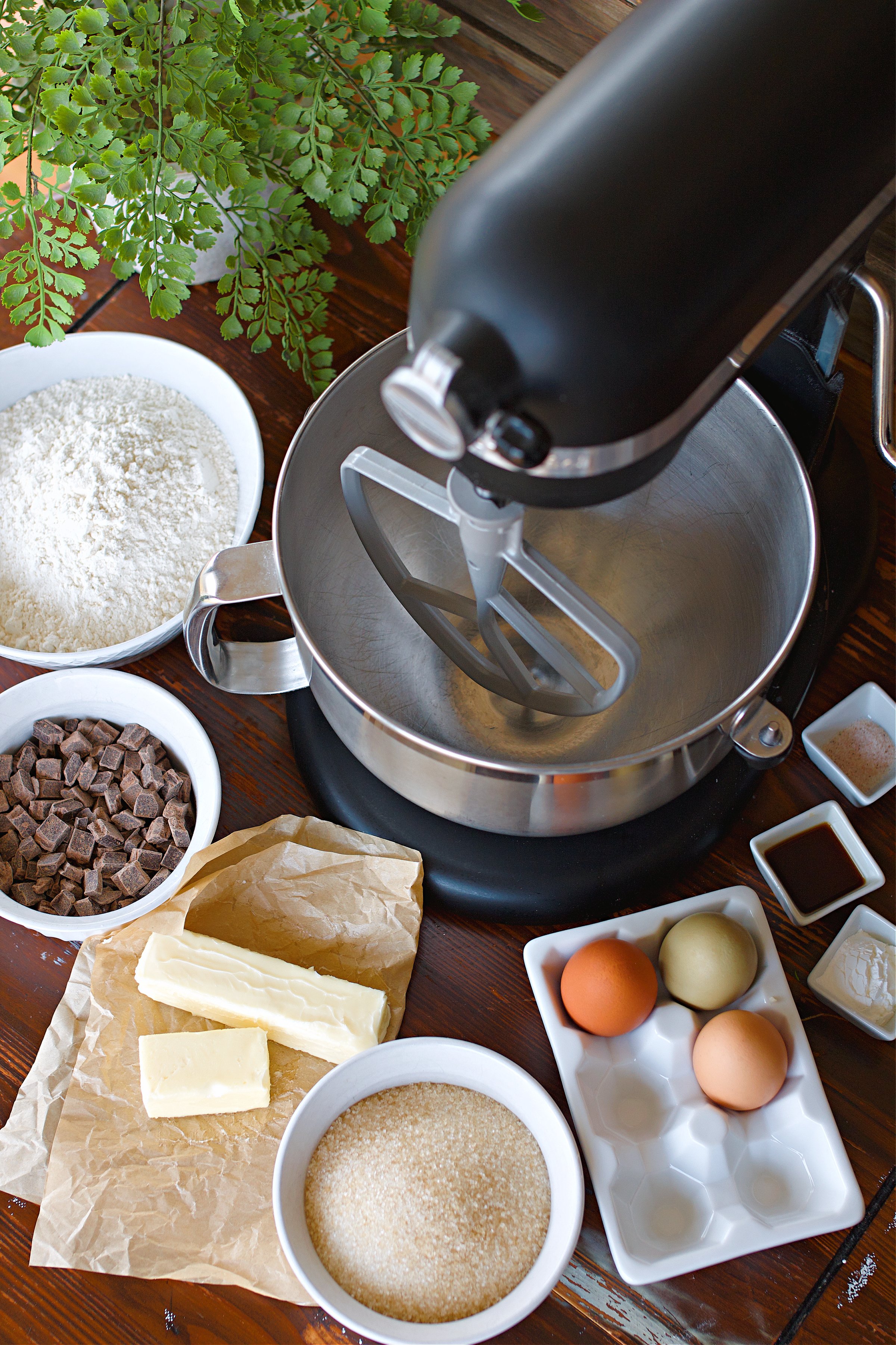 Ingredients for Biscottis on counter surrounding kiten aid mixer.