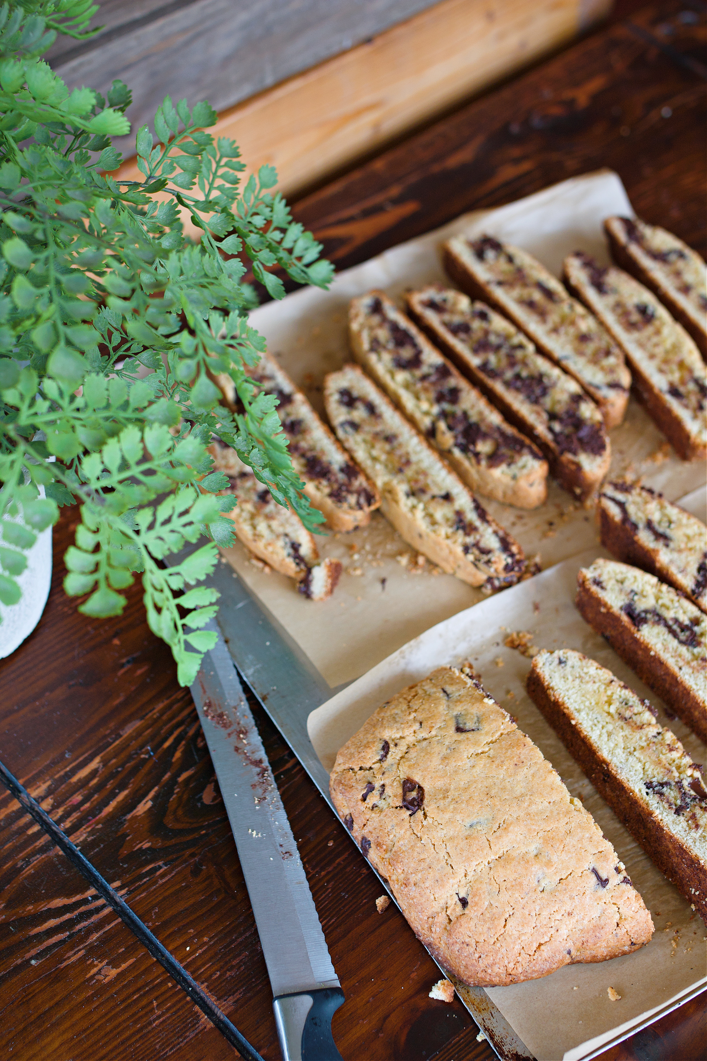 Biscotti on counter after being baked the first time, gettin cut into their biscotti shapes.