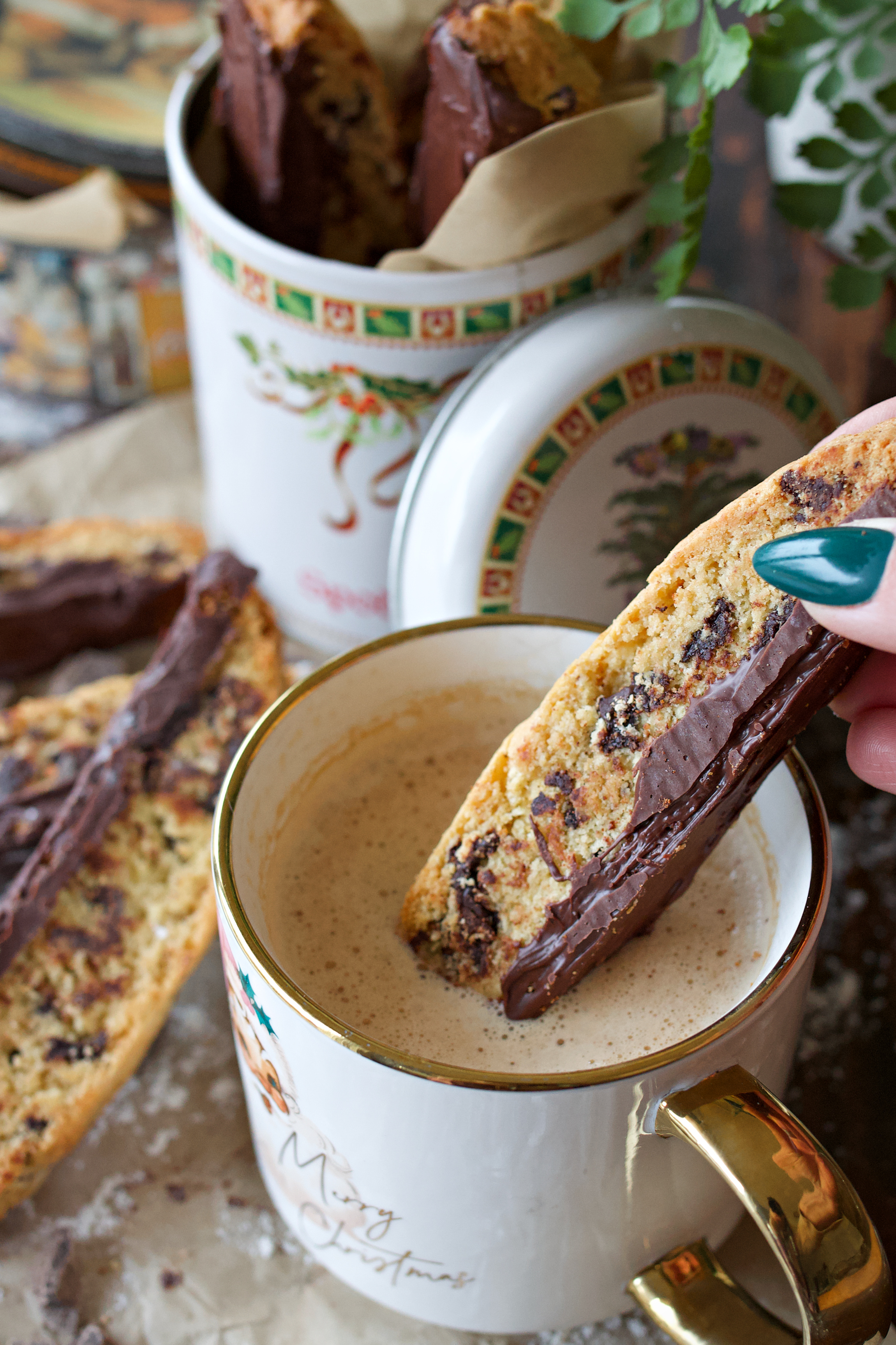 Biscotti being dipped in a cup of coffee.