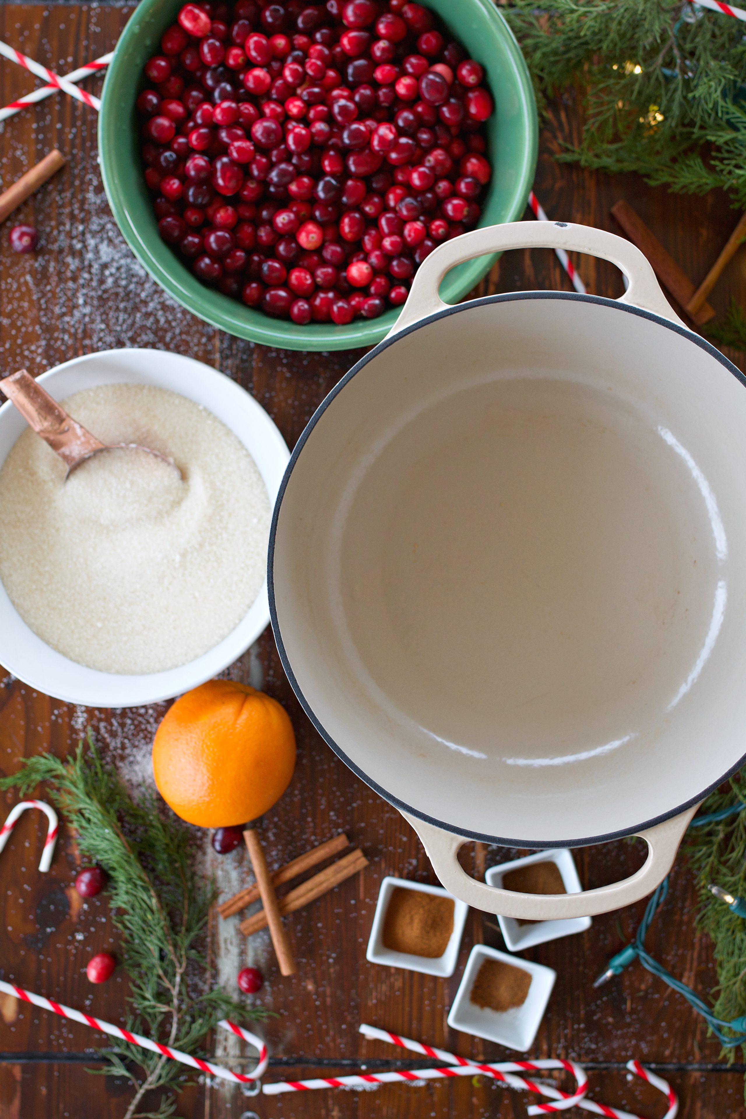 ingredients for Cranberry jam on counter: fresh cranberries, sugar, spices, and orange.