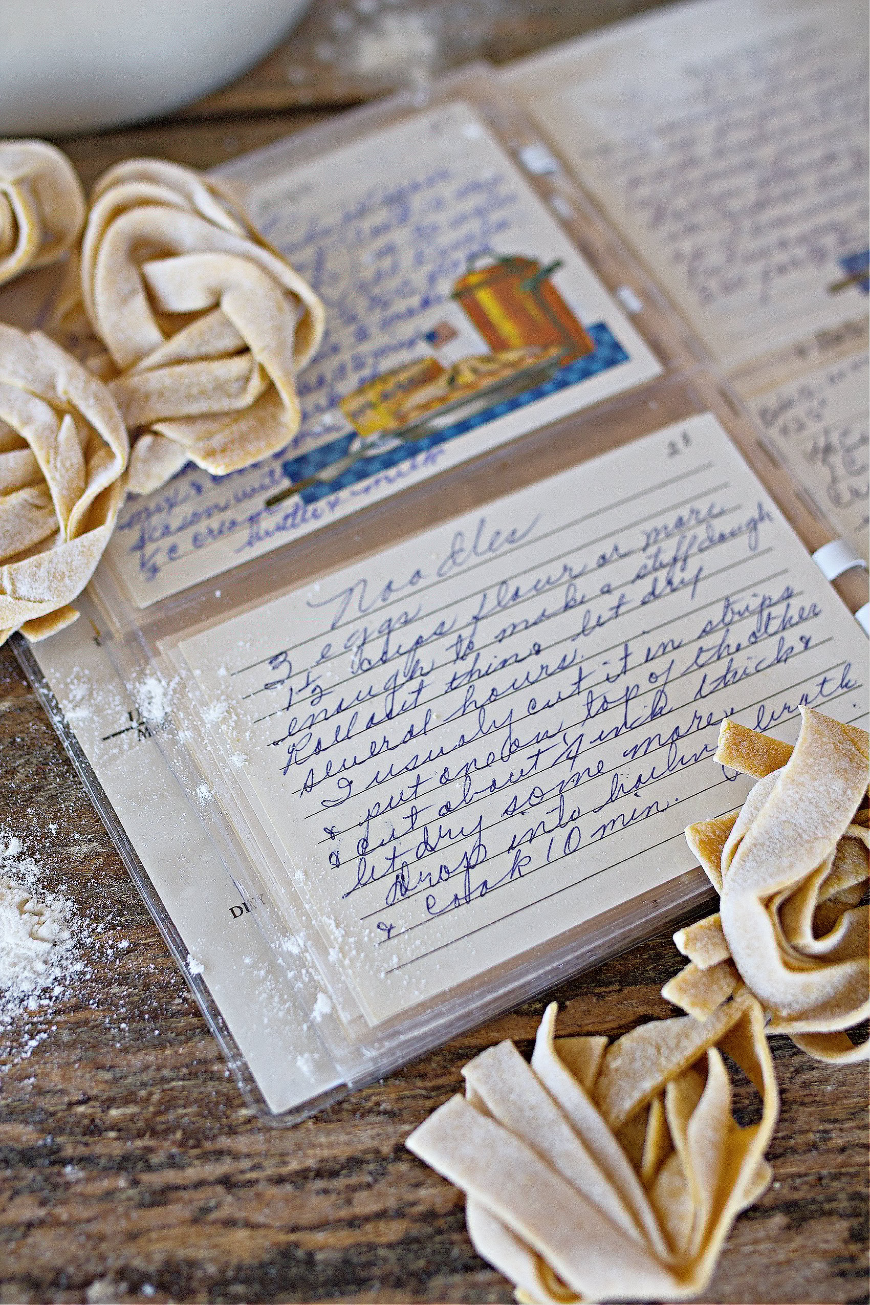 noodles on counter next to recipe card.