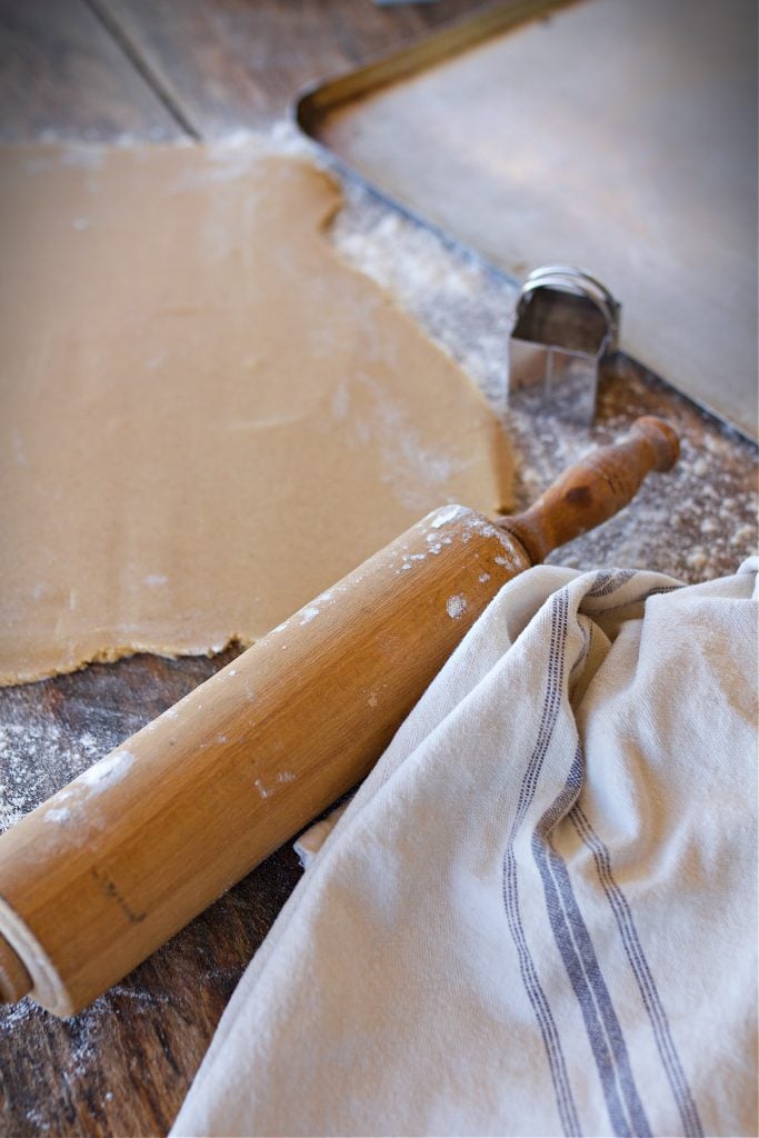 Rolled dough with rolling pin and farmhouse towel.