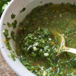 Close up of chimichurri sauce in a white bowl