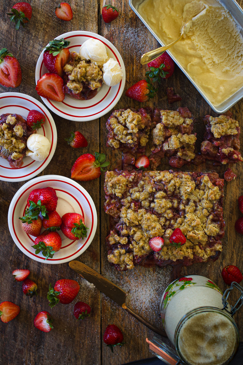 plated strawberry rhubarb crisp next to the cut up bars.