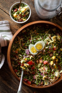 Pea salad in a wooden bowl.