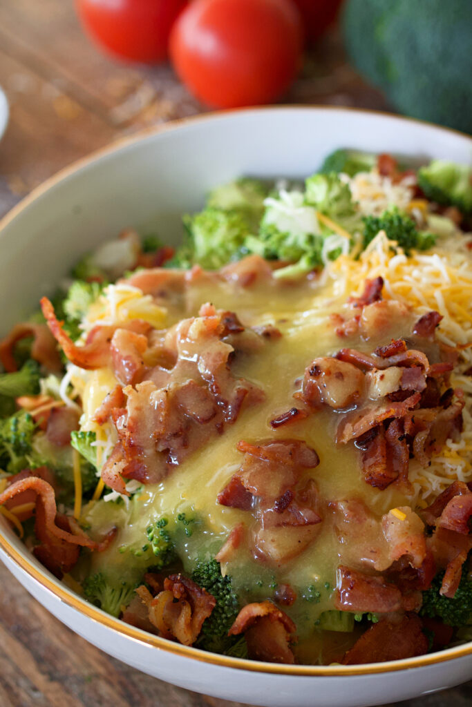 broccoli salad with dressing drizzled over top.