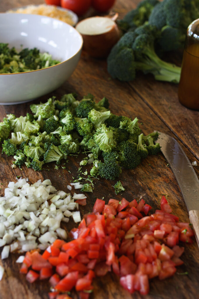 broccoli salad chopped ingredients on wooden counter