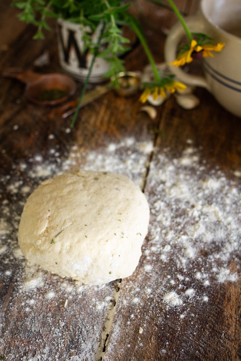 ball of dough on wooden counter.