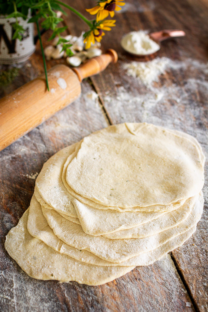 flatbread rolled out on counter ready to be cooked in a skillet.