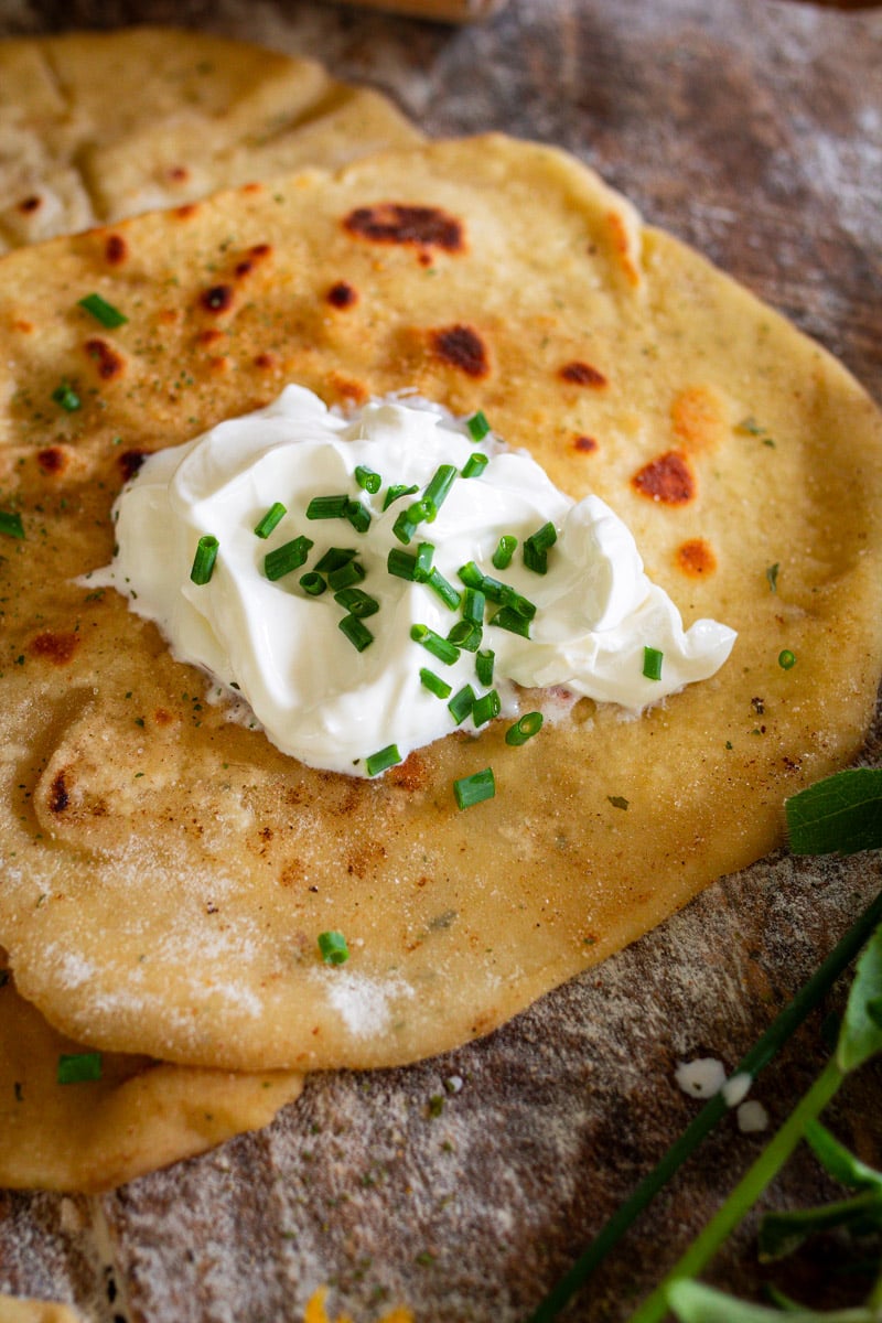 sourdough discard flatbread with dollop of sour cream in middle.