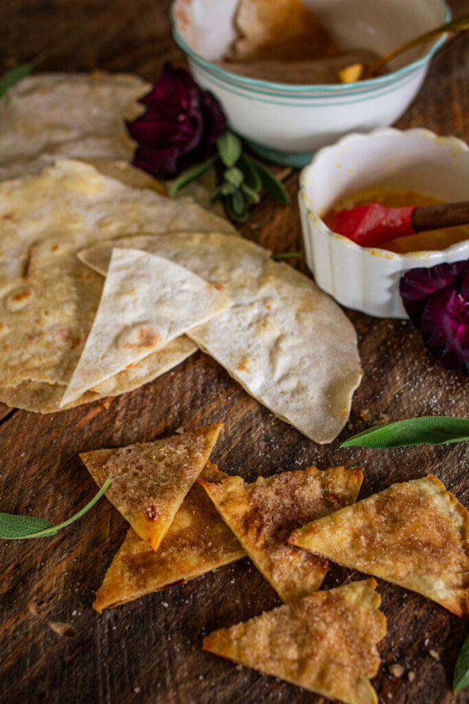 tortillas being cut up to turn into cinnamon sugar chips.