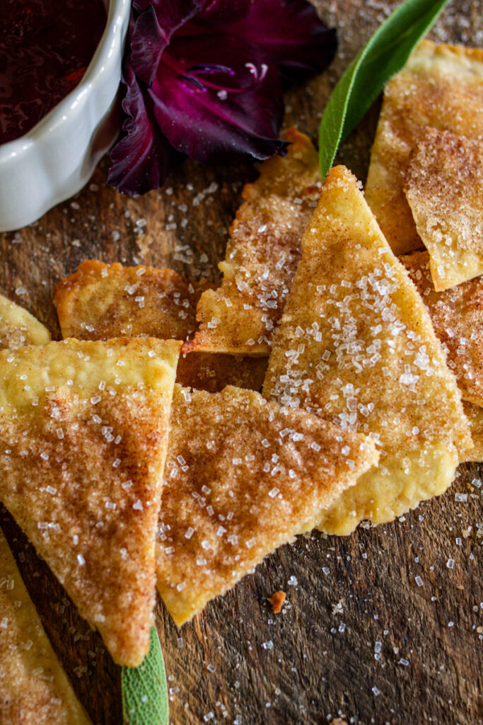 Cinnamon sugar chips on counter next to a jam dip.