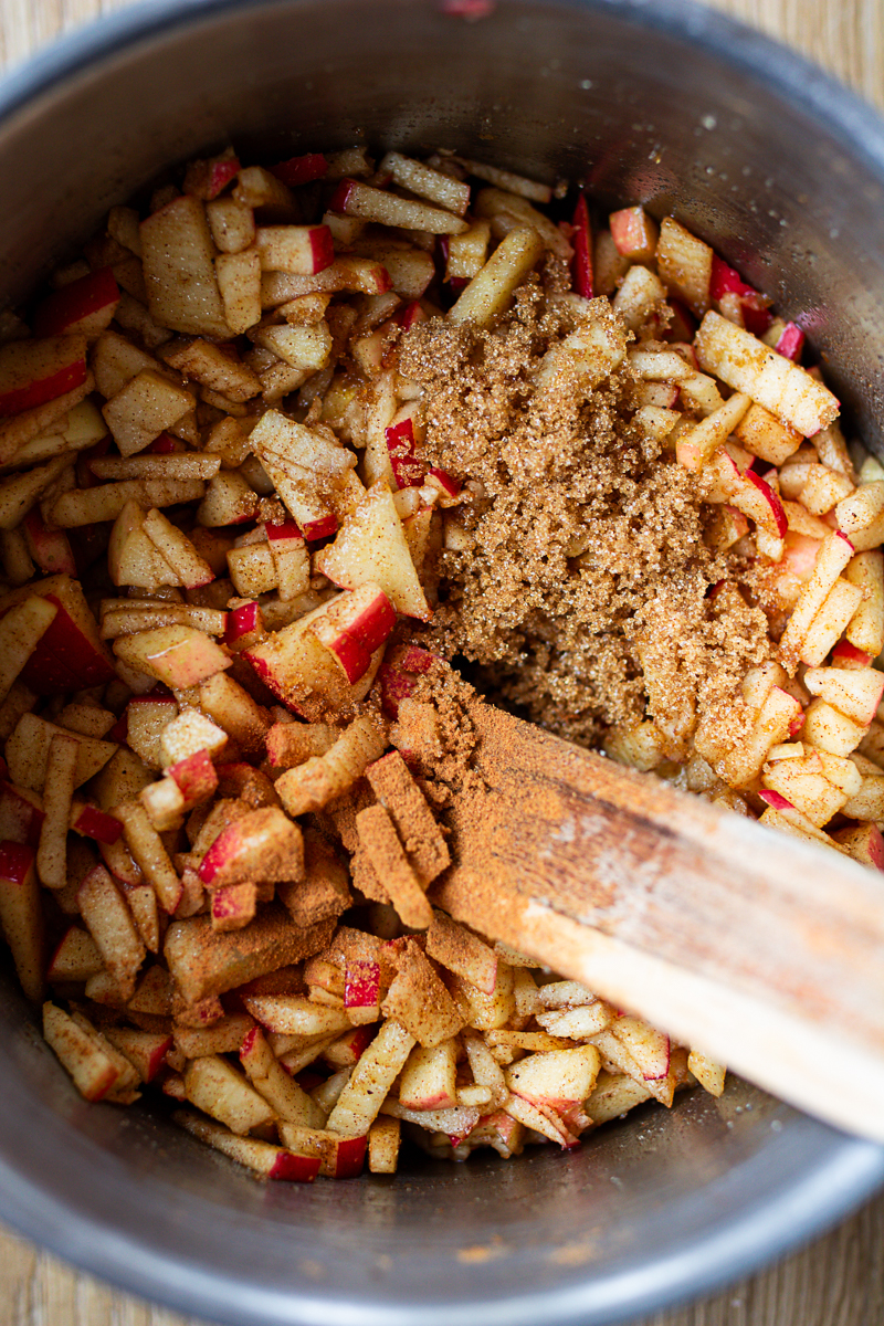 chopped apples with spices in stainless steel pot.