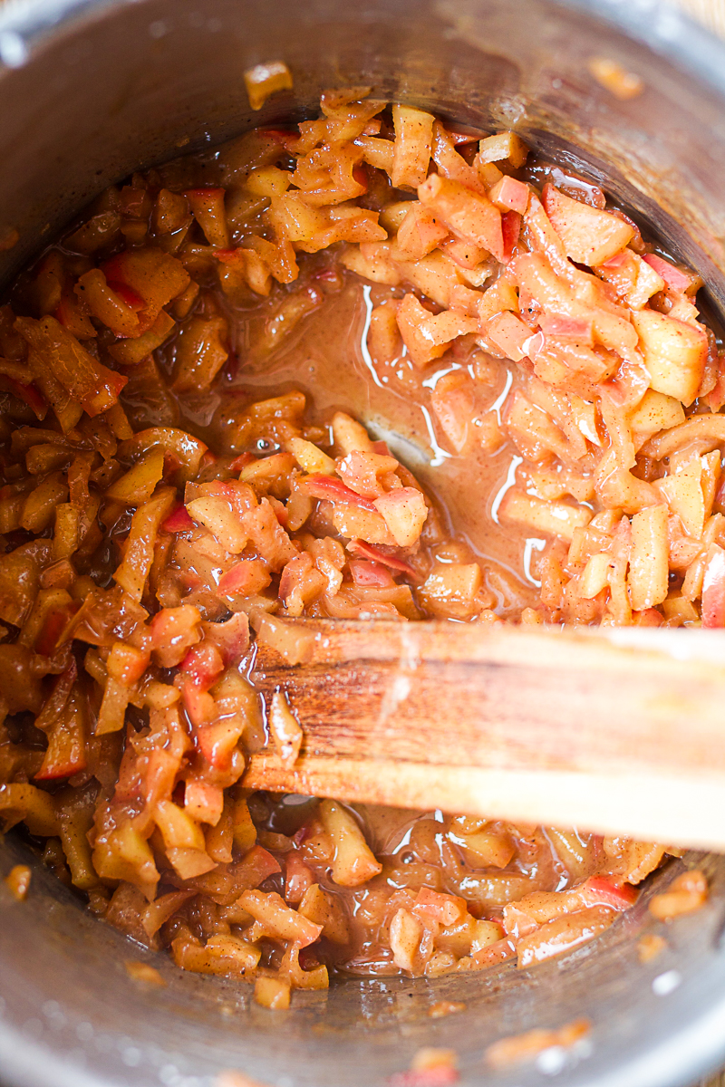 cooked down apple filling in stainless steel pot.