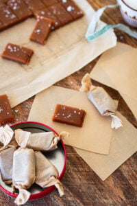 Caramels being wrapped in parchment squares.