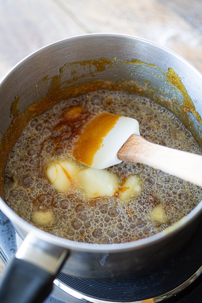 adding butter to the melted sugar. 