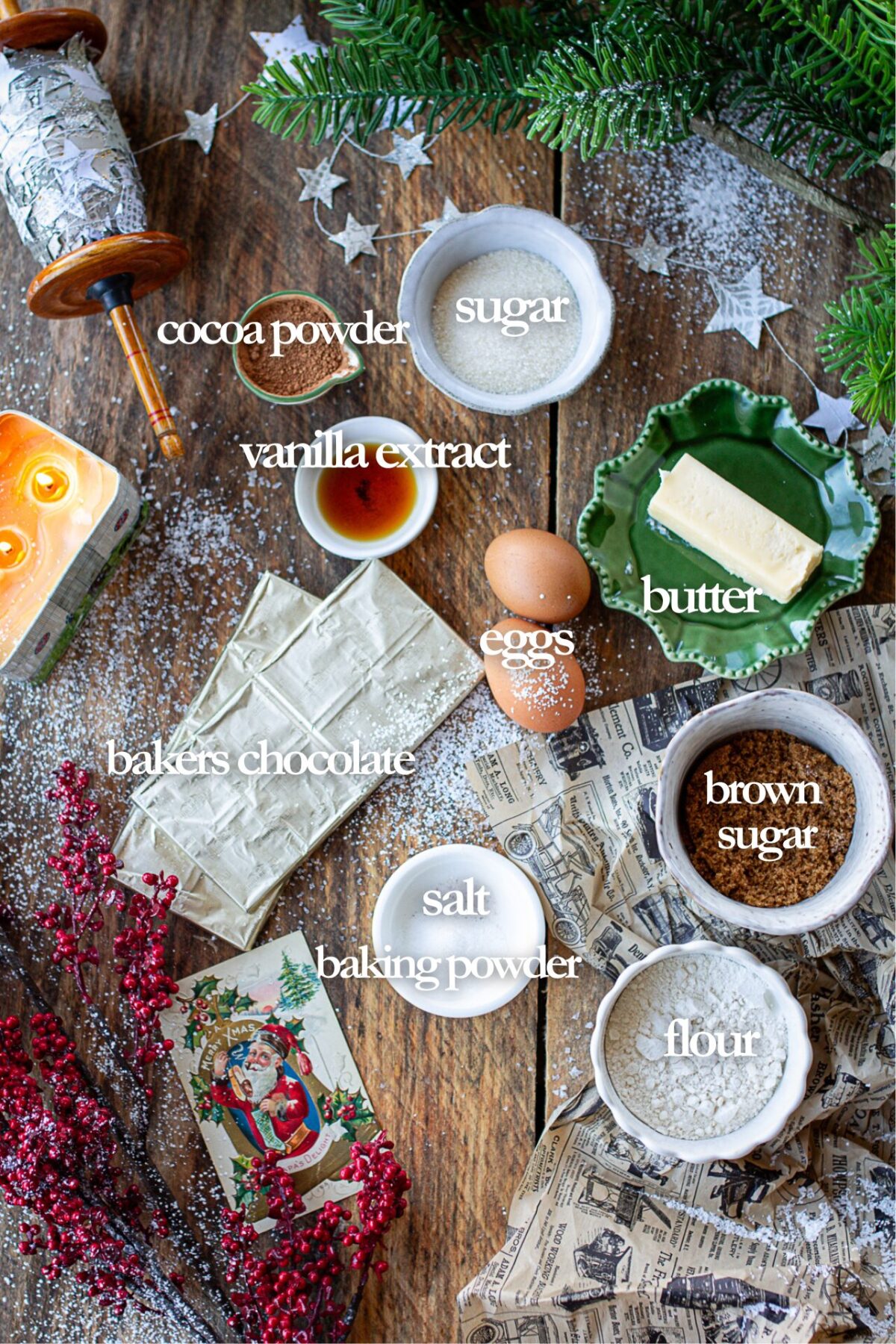 Ingredients for cookies on counter: sugar, eggs, cocoa powder, vanilla extract, butter, chocolate bars, brown sugar, salt, baking powder, flour. 