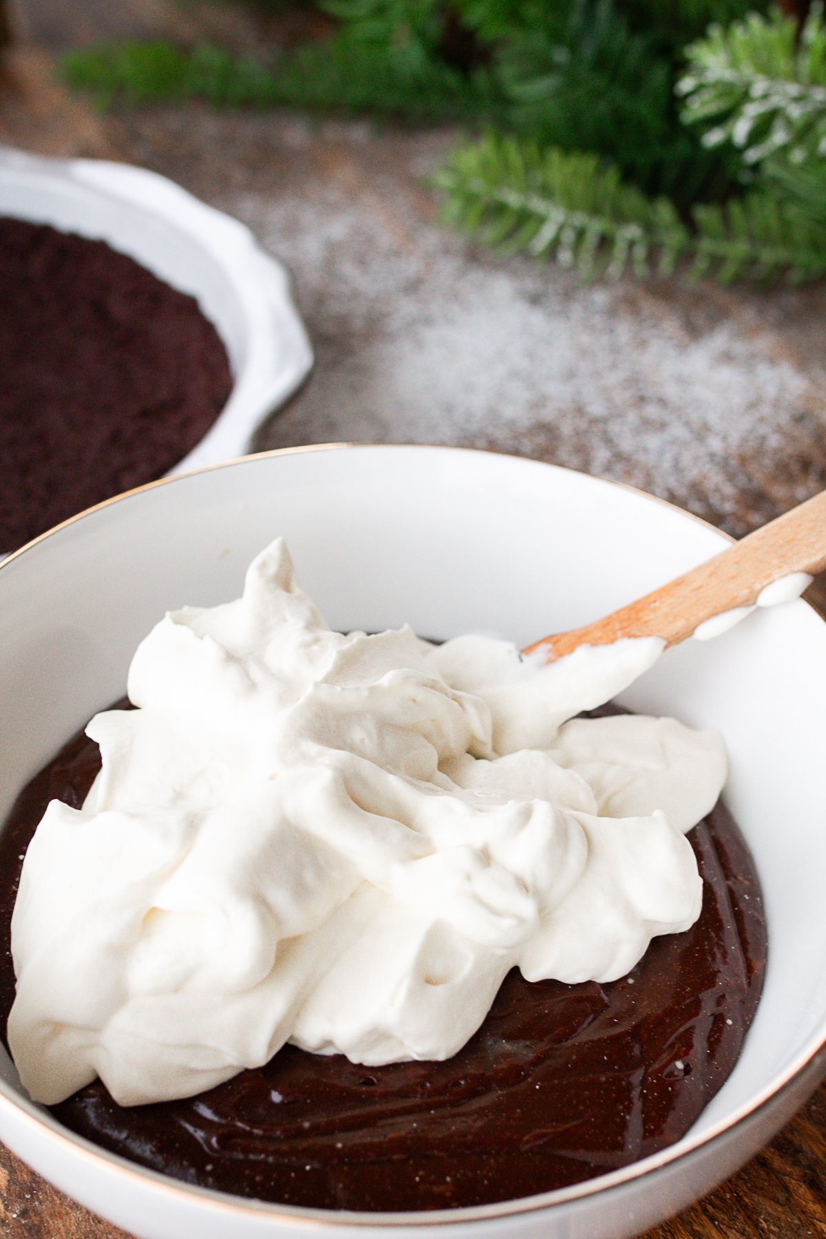 whipping cream on top of chocolate mixture ready to incorporate.
