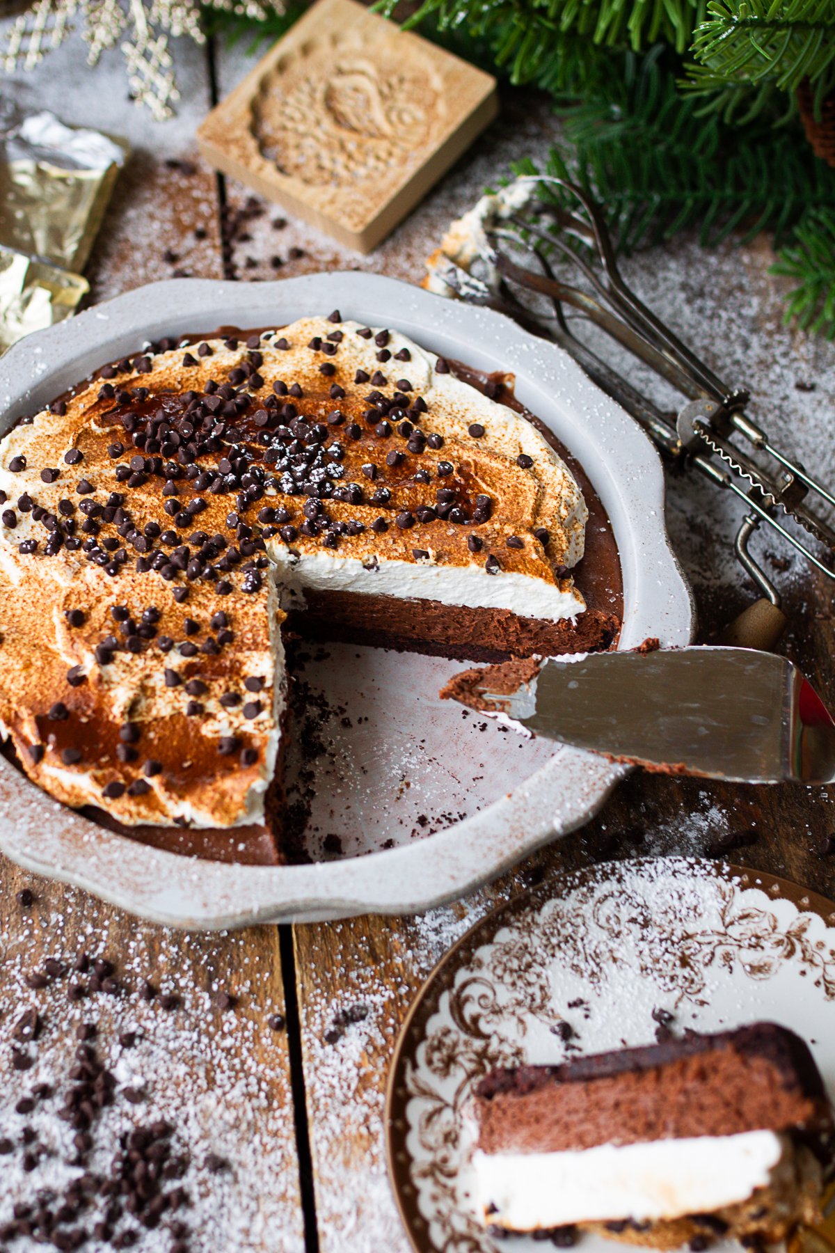 Pie on counter with sliced piece on serving plate beside it.