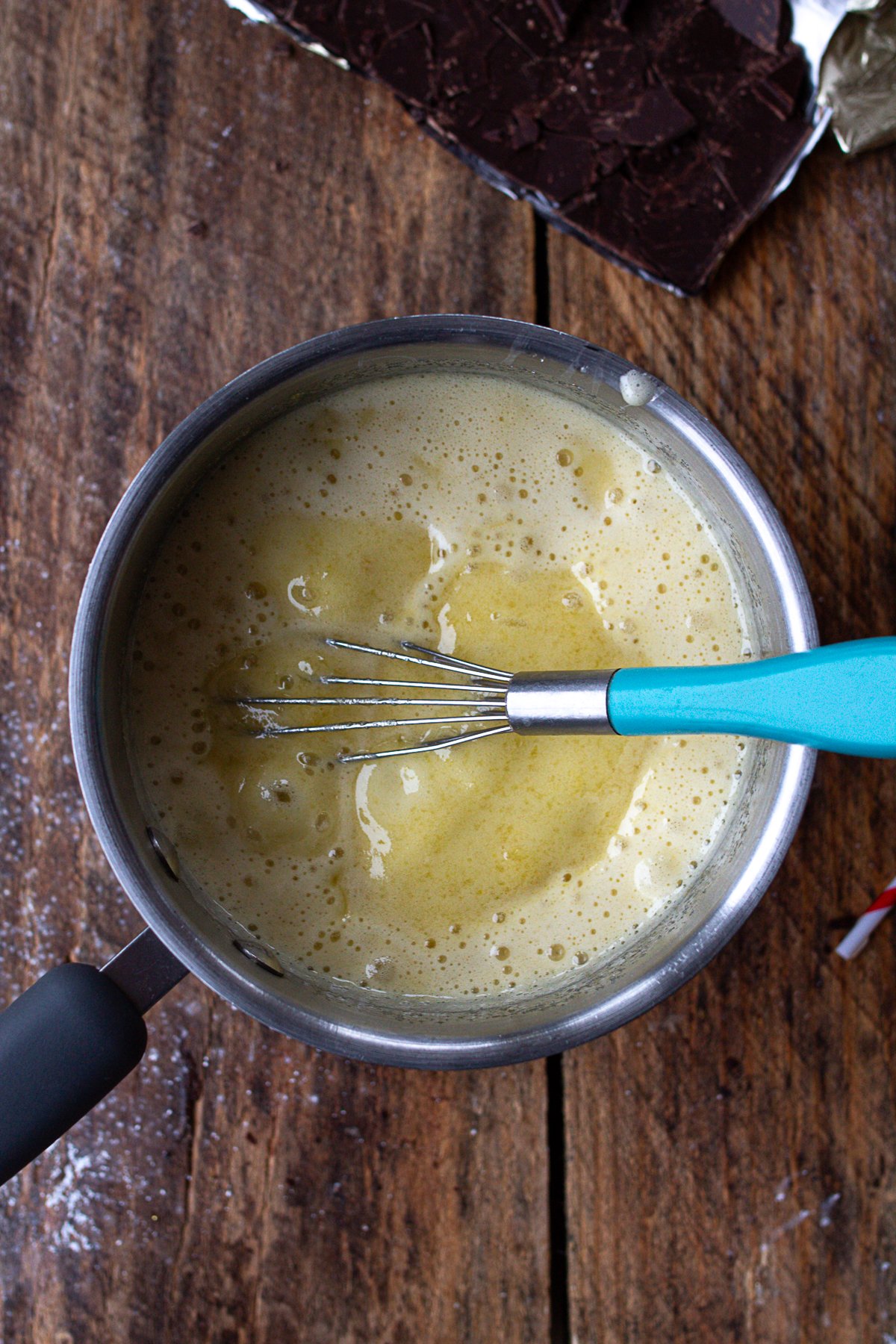 Saucepan with base pie filling of eggs and sugar boiling.