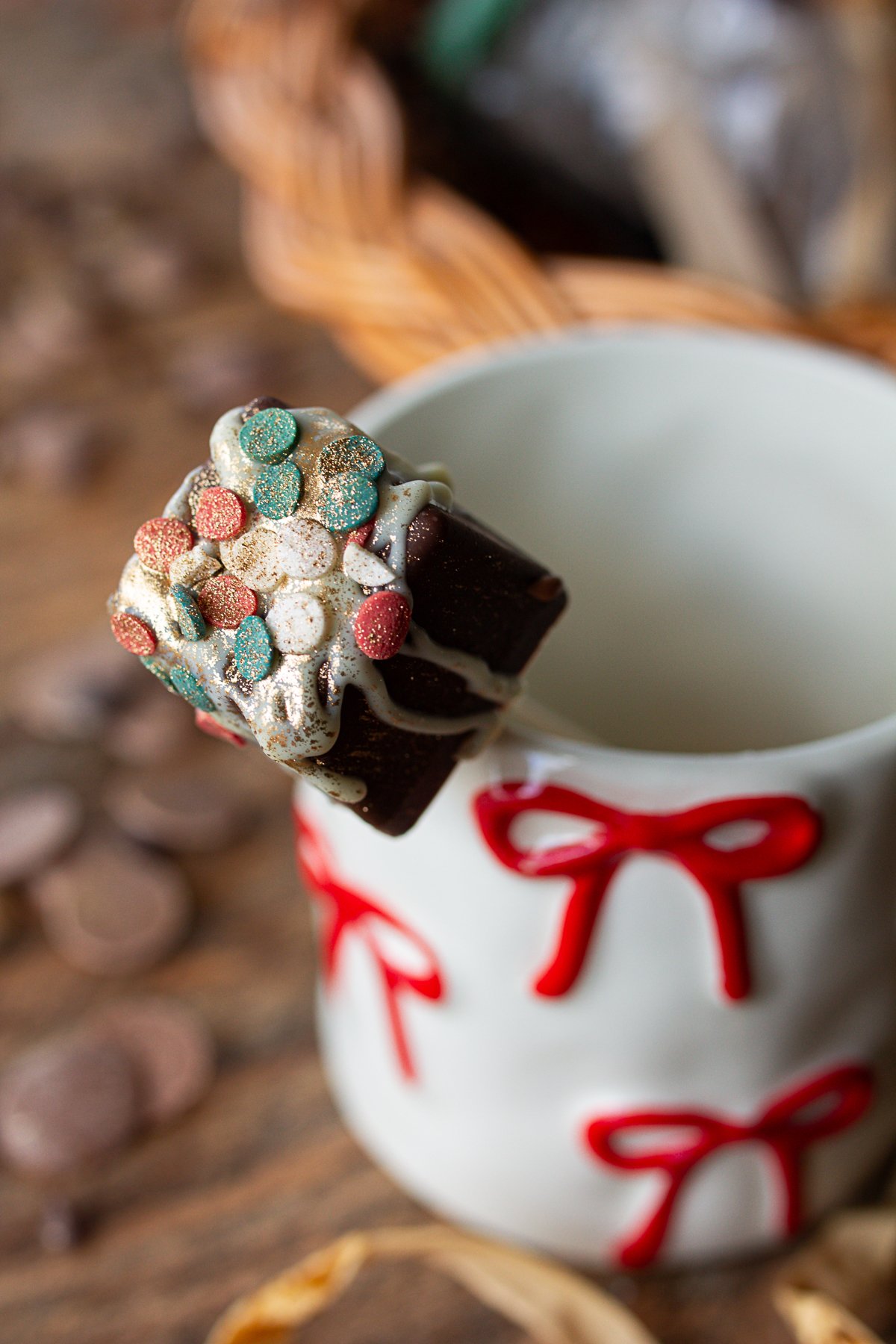 Hot cocoa spoon standing in empty coffee cup ready to be used.