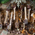 Nine hot cocoa spoons on counter ready to be wrapped and gifted.