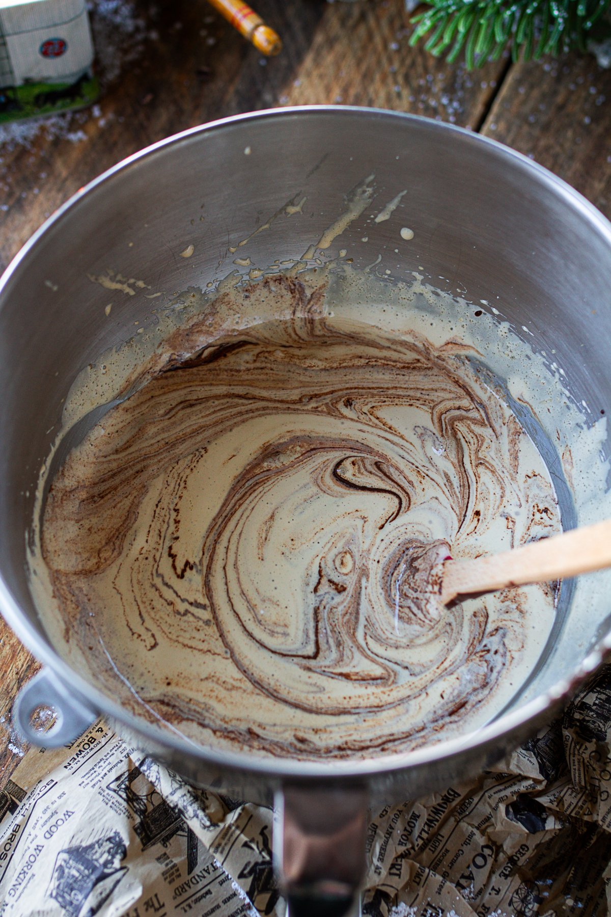 Chocolate mixture added to egg mixture being mixed to combine. 