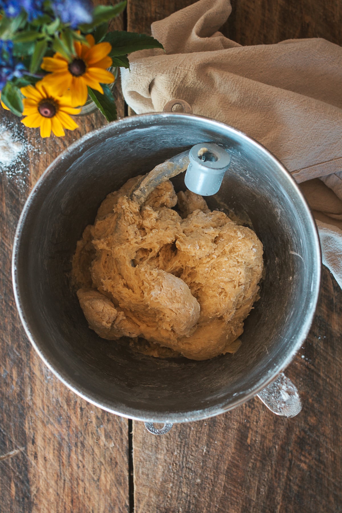 Shaggy brioche dough in a stand mixer before adding butter.