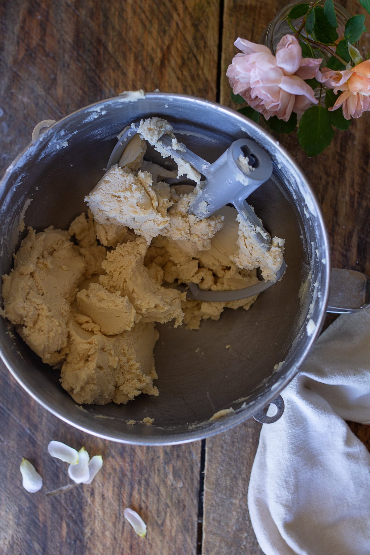 Soft homemade shortbread cookie dough inside a stand mixer bowl with a paddle attachment.