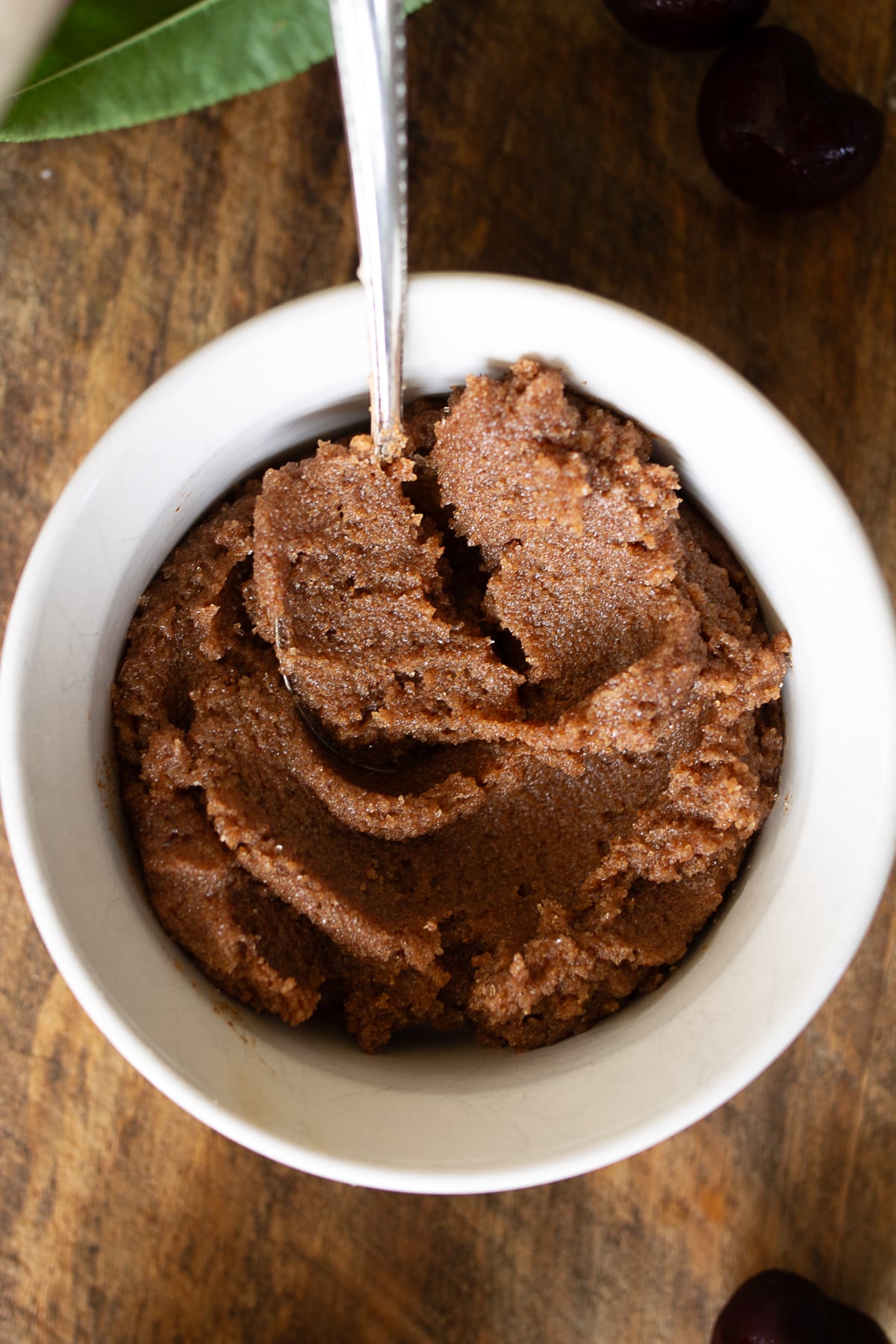Close up view of cinnamon sugar butter filling paste mixed in a white bowl with a spoon
