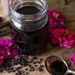 Mason jar filled with homemade elderberry syrup made from dried elderberries