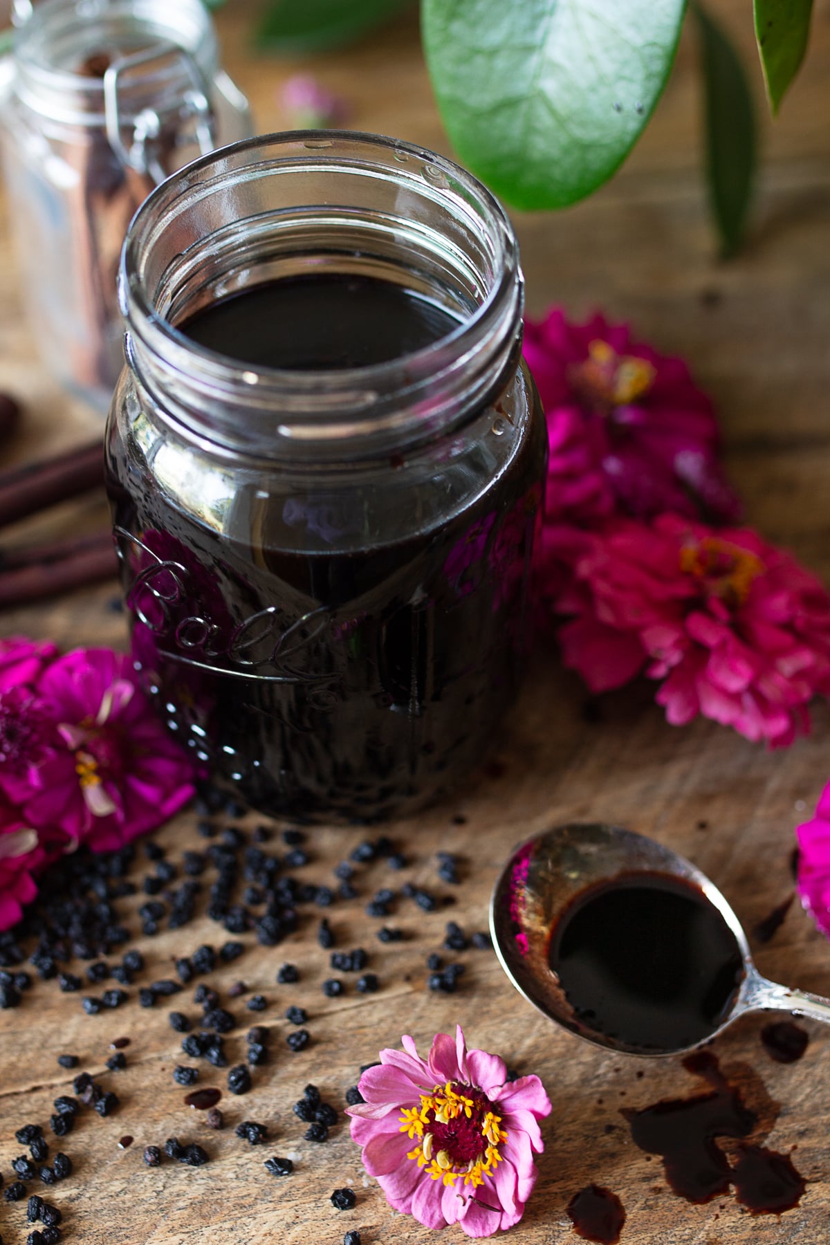 Mason jar filled with homemade elderberry syrup made from dried elderberries
