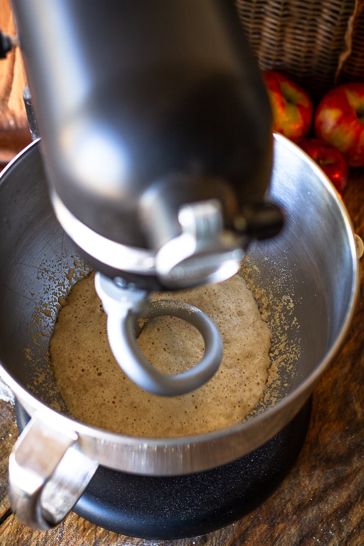 Stand mixer bowl with a dough hook proofing active dry yeast, warm milk, and sugar until foamy.